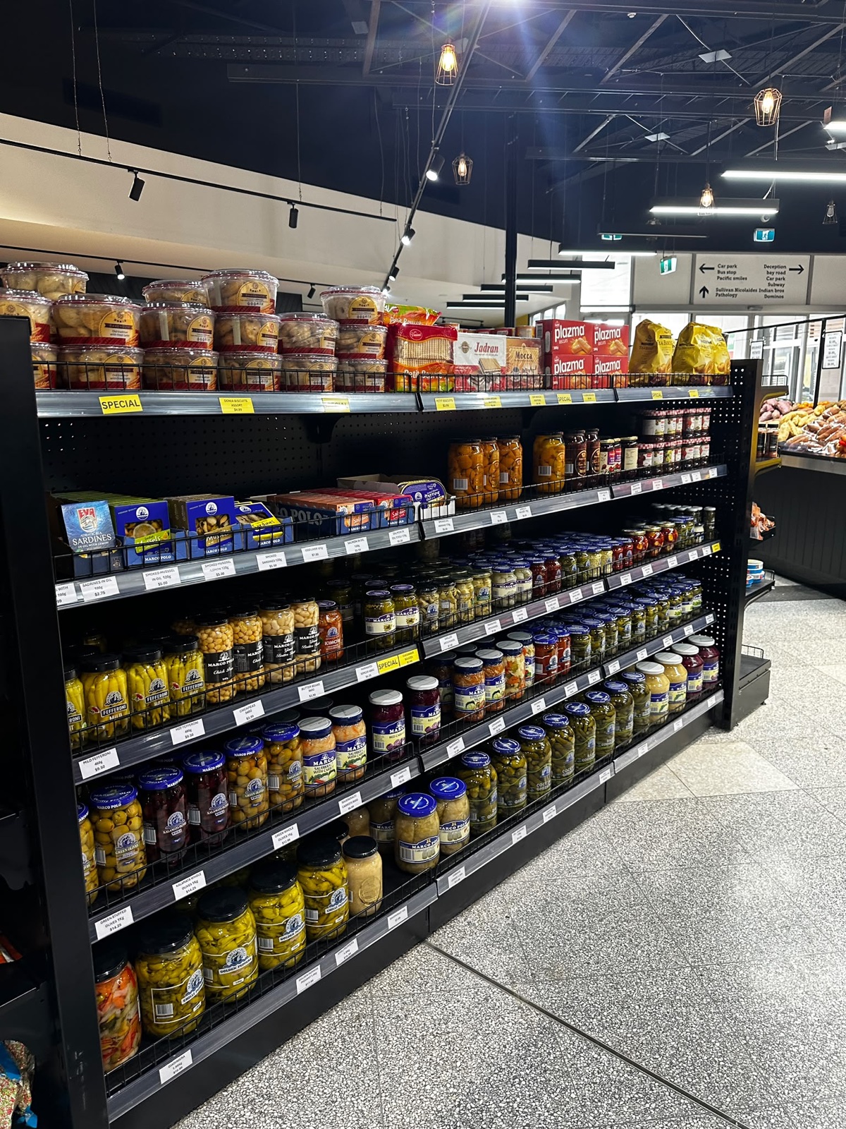 Shelves of jars, biscuits, pickles and pantry products